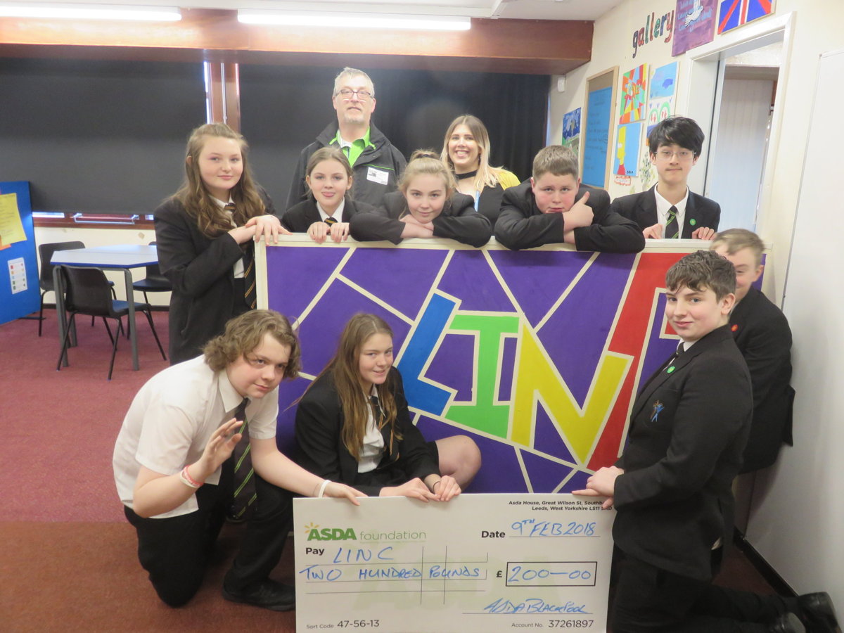 Image of LINC awarded with cheque from ASDA